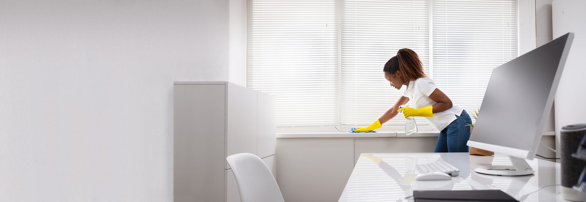 A female is doing the cleaning in the office room, office cleaning services